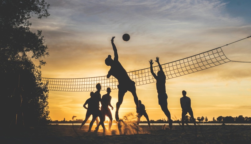 Beach volleyball at sunset